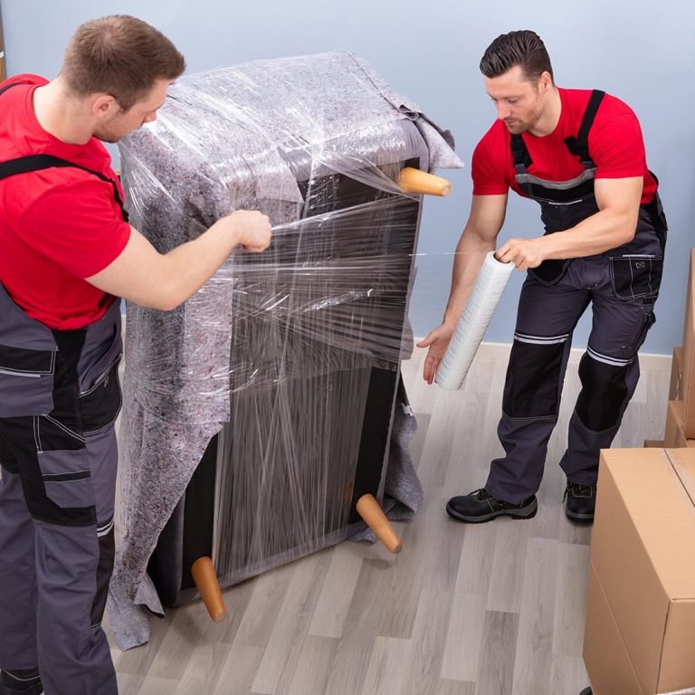 back-two-removal-company-workers-unloading-boxes-from-minibus-into-new-home